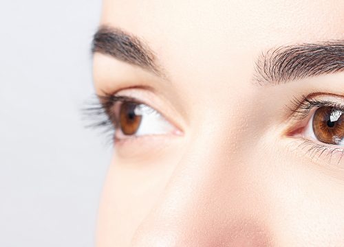 Close-up on a woman's eyes and brows after permanent makeup