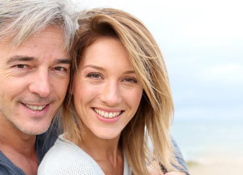Happy middle-age couple at the beach